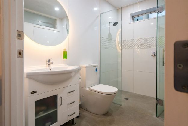 Shower toilet and hand basin in modern bathroom